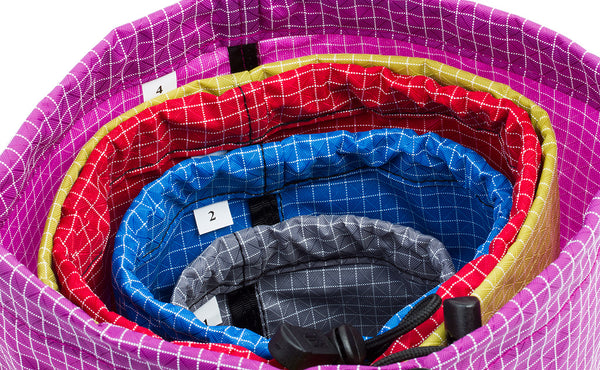 All 4 sizes of Travel Stuff Sack, each seated in the size higher numbered size (i.e. a size 4 holding a size 3 holding a size 2 holding a size 1).